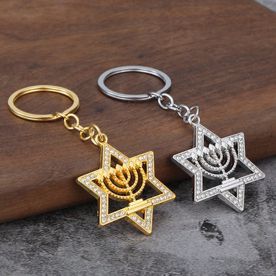 Silver-tone and gold-tone keychains displayed together on a wood surface.