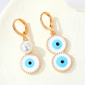 Gold Tone Asymmetric Pearl and Evil Eye Huggie Drop Earrings view 1