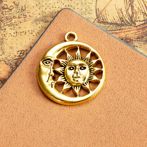Closer view of the sun and crescent moon face charm surface and openwork details