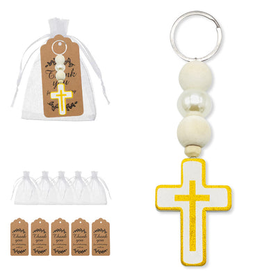 Set overview showing the cross bead keychain, white organza bags, and brown thank-you tags.