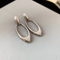 Open Oval Sculptural Drop Earrings In Gold And Silver Tone view 7
