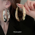 Wide Polished Hoop Earrings In Gold And Silver With Decorative Details view 1