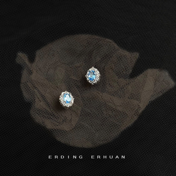 Silver Tone Pale Blue Oval Stone And Clear Floral Halo Stud Earrings