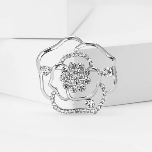 Silver crystal openwork rose brooch on white platform