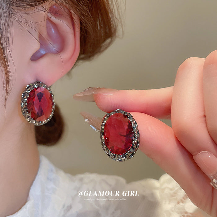 Dark Silver Tone Oval Stud Earrings With Faceted Red Centers