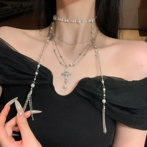 Product display of silver tone cross and pearl necklace with layered drop chains