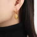 Gold Huggie Hoop Earrings with Cowrie Shell Dangle Charms view 3
