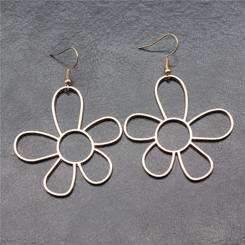 Alternate angle of open flower drop earrings showing open five-petal flowers suspended from fishhook ear wires