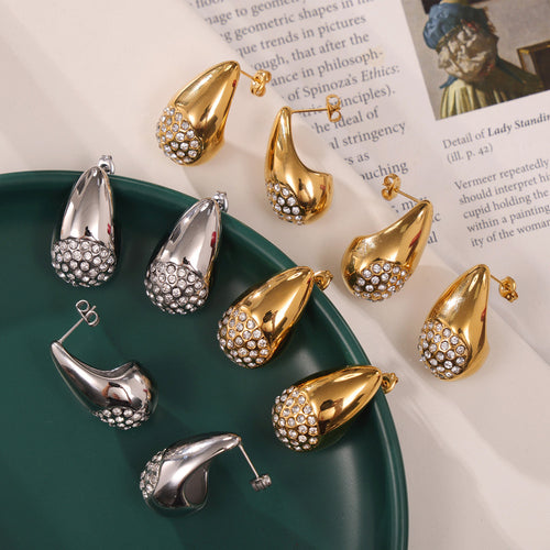 Close-up gold teardrop zircon cluster stud on ear