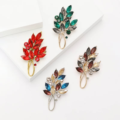 Front product view of the two leaf crystal branch brooch on a light background