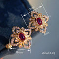 Gold Tone Open Flower Red Center Clear Pavé Stud Earrings view 4