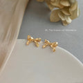 Gold Tone Sculpted Bow Stud Earrings With Stitched Ribbon Detail view 6