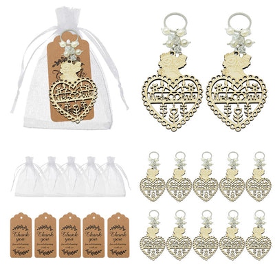 Keychains displayed with white organza bags and printed thank-you tags.