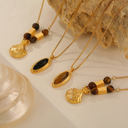 Gold shell bead pendants and oval black and tiger-eye framed pendants