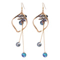 Blue Crystal Twisted Loop Dangle Hook Earrings with Polished Metal Details view 5