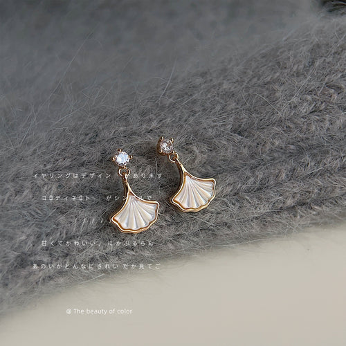 Gold-tone clear-stone-top white-ginkgo-leaf studs in the first product display.