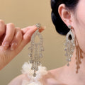 Long Crystal Chandelier Earrings in Gold and Silver Tones view 1