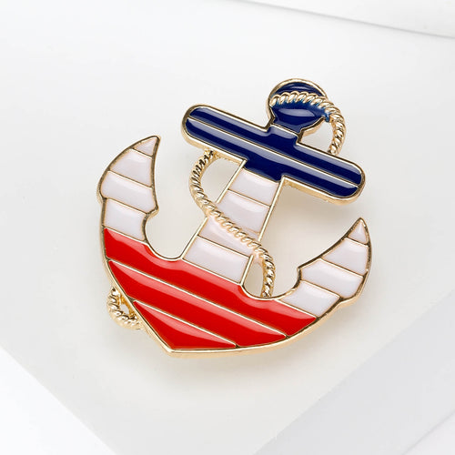 Angled display of the anchor sailboat brooch on a white surface
