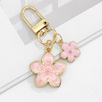 Pink resin flower duo charm keychain with gold-tone lobster clasp
