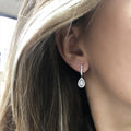 Silver Teardrop Halo Dangle Earrings In A Polished Decorative Design view 1