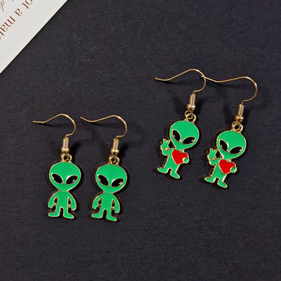 Plain green and heart alien enamel fishhook earring pairs on dark