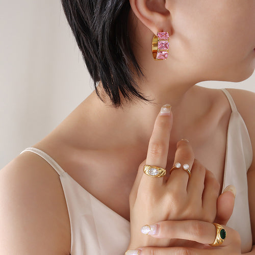 Model wearing gold C hoop three pink square crystals on ear