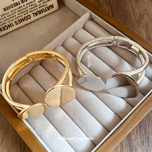 double-loop irregular pebble hinged bracelet in gold-tone or silver-tone finishes shown in the first close product view