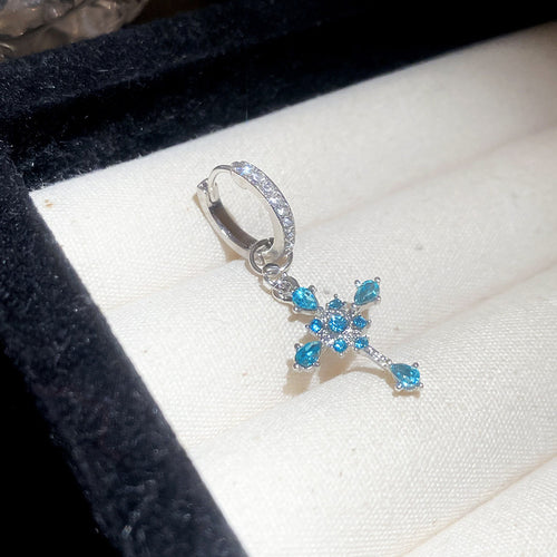 Main image 1 showing two silver-tone clip earring styles with crystal crosses in multicolor or blue, styled product view