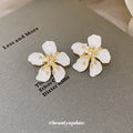 White Textured Flower Stud Earrings with Gold Tone Centers view 4