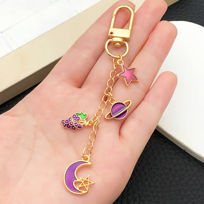 Overview showing the available color and design variations of the purple and blue celestial metal clasp keychain