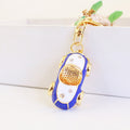 Car-Shaped Metal Keychain With Gold-Tone Trim and Clear Stone Accents view 4