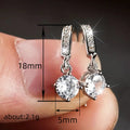 Round Clear Solitaire Bar Drop Earrings In Three Metal Tones view 4