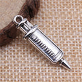 Short Syringe Double-Sided Metal Charm in Two Antique Finishes view 2