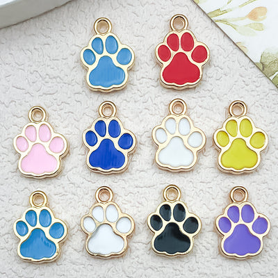 Colorful cat paw charms arranged on a light background