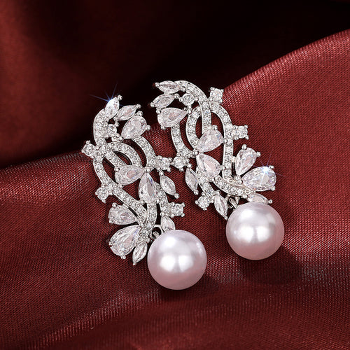 Silver Tone Leaf Cluster Faux Pearl Drop Earrings with Clear Stone Accents shown in styled view