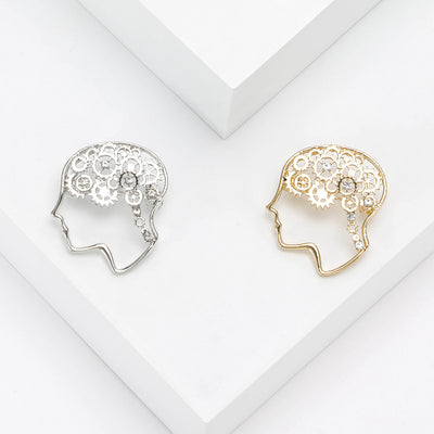 Front view of a side-profile head outline filled with floral brain-like filigree