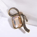 Crystal Ribbon Loop Brooch with Polished Metal and Decorative Accents view 4