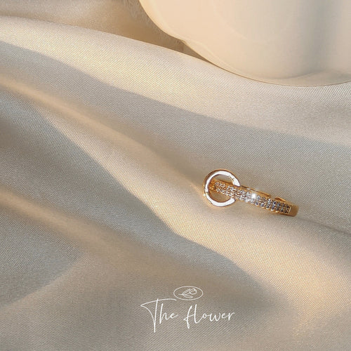 Gold crystal band ring with circle on beige silk