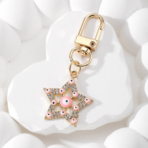 Close-up showing the colors and surface details of gold Tone Rhinestone Star Evil Eye Clip Keychains in Four Colors