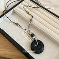Black and Brown Cord Necklaces with Round Wood Look Pendants view 3