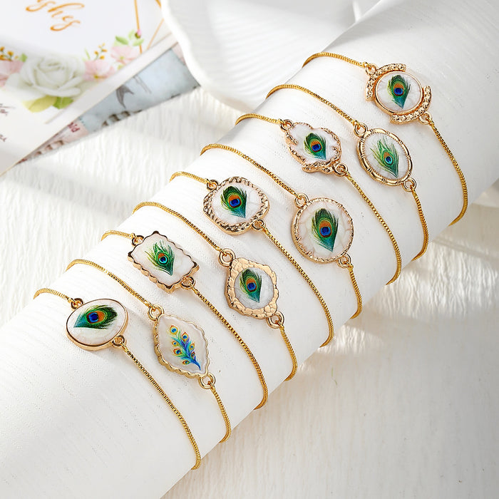 Gold Tone Peacock Feather Evil Eye Slider Bracelets in Nine Shapes