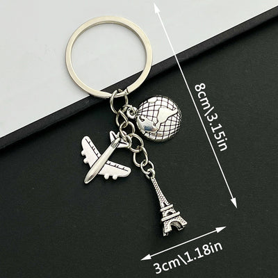Front product photo of antique silver airplane globe and eiffel tower travel charm keychain showing the pictured design 