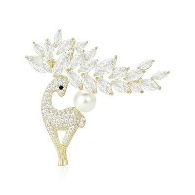 Gold crystal deer brooch with pearl and leaf antlers on white