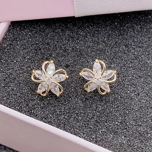 Gold flower clear stone studs in pink jewelry box