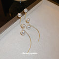 Curved Gold Tone Wire Earrings With Pearl Beads With Polished Metal Tone Details view 2