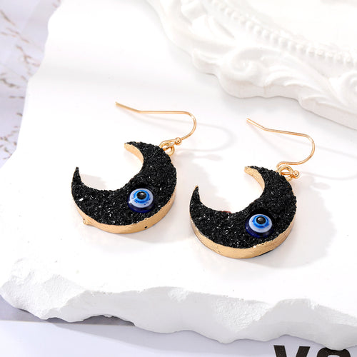 Black glitter crescent moon earrings with blue white evil eye beads gold hooks