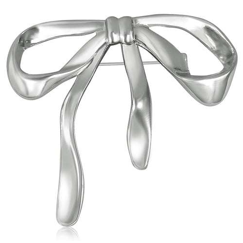 Sculpted Metal Bow brooch In Gold And Silver Tone Decorative Lapel Pin shown in styled product arrangement