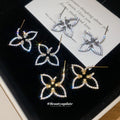 Open Flower Outline Stud Earrings in Gold and Silver view 1
