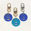 Gold Tone Round Enamel Eye and Celestial Clip Keychains view 1