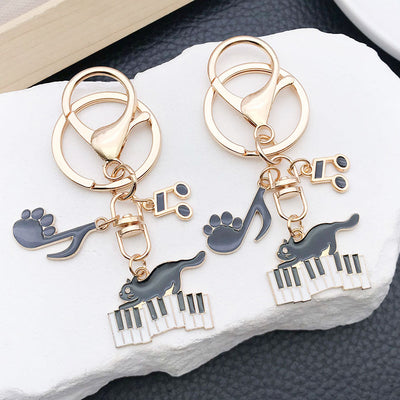 Main display of black cat music keychains in six charm arrangements
